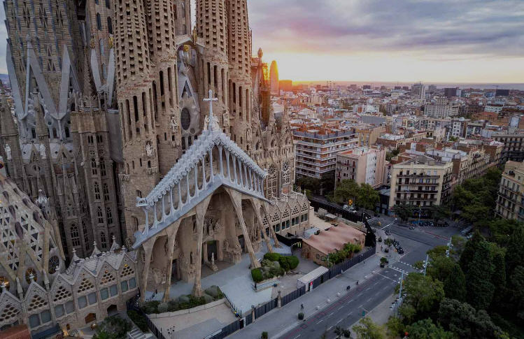 Panoramic view of Barcelona's vibrant cityscape, with colorful buildings, winding streets, and bustling plazas.