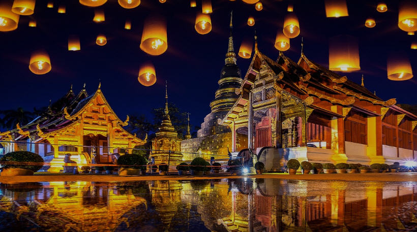 Panorama of Chiang Mai, Thailand, with lush mountains, ancient temples, and bustling city streets