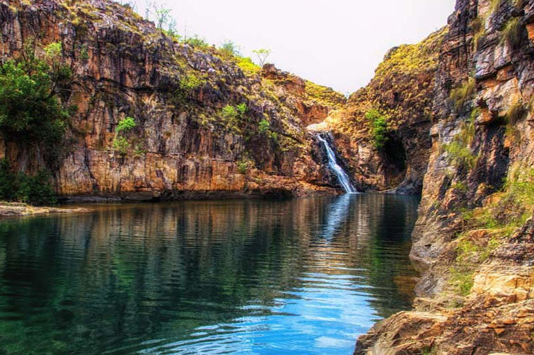 Cascading Jim Jim Falls in Kakadu National Park, plunging into a lush green gorge.