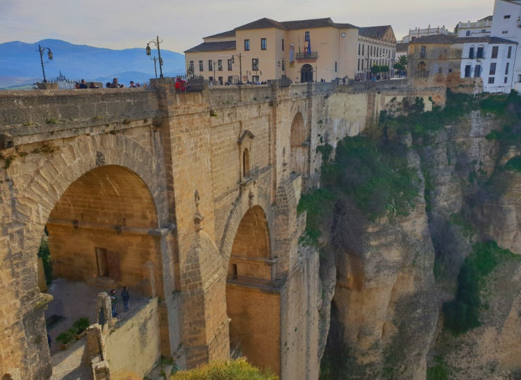The iconic Puente Nuevo bridge in Ronda, Spain, spanning the El Tajo gorge with the whitewashed town in the background.