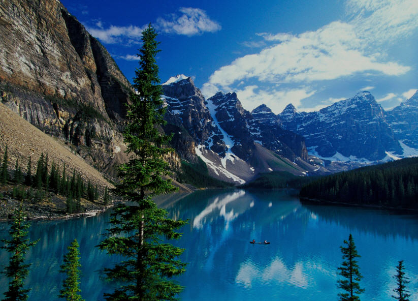Panoramic photo of Jasper National Park at dusk, with long shadows cast across a valley and vibrant colors in the sky.