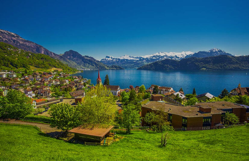 Historic Old Town of Lucerne, featuring cobblestone streets, colorful buildings with painted facades, and a bustling waterfront.