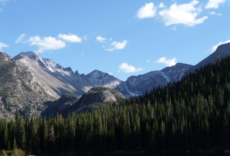 Rugged peaks of the Rocky Mountains in Rocky Mountain National Park, dotted with alpine lakes and dense forests.